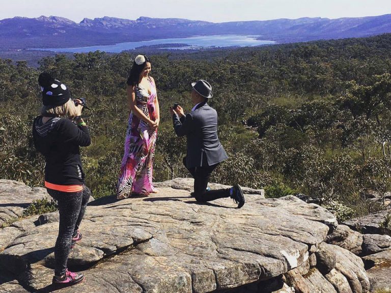 proposal photography showing behind the scenes image of female wedding photographer Lowina Blackman shooting candid moment of a surprise proposal at the Grampians Australia 2017 Summer