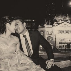 bride groom portrait kissing in front of Flinders Street Station by Black Avenue Productions