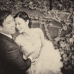 Happy bride and groom joking and laughing in black and white wedding photo style