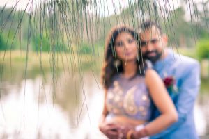 artistic fine art wedding photography example of newly wedded couple posed by the lake in Baxter Barn
