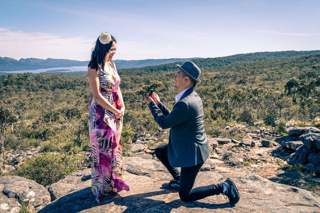 boyfriend surprise his girlfriend with an engagement ring on hand and propose by the balconies at Reeds look out in Australia hill cliff