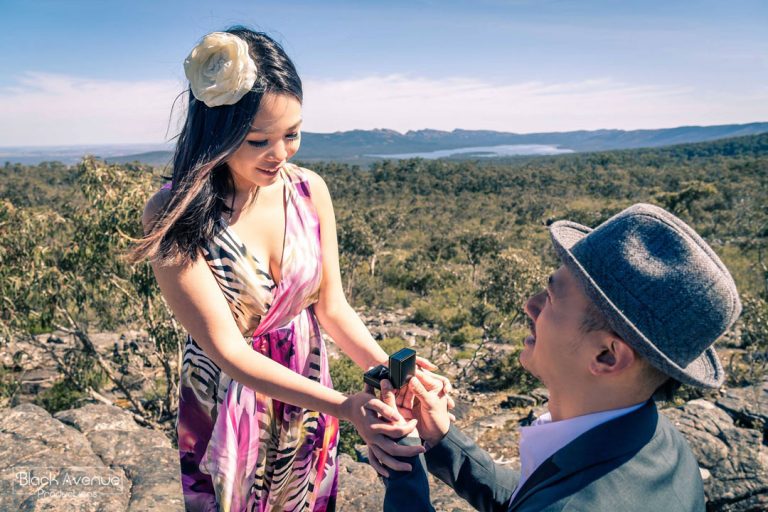 happy girlfriend accepting her engagement ring during a surprise marriage proposal moment captured by Black Avenue Productions in a stunning hilltop view sunrise