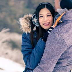 beautiful couple hugging for their winter engagement photo session