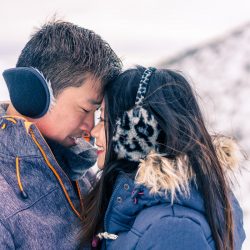 couple nose to nose by snow mountain background in Australia Victoria captured by wedding photographers Black Avenue Productions 2018