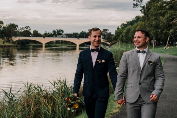 happy gay boyfriends holding hand walking under sunset near Richmond Melbourne