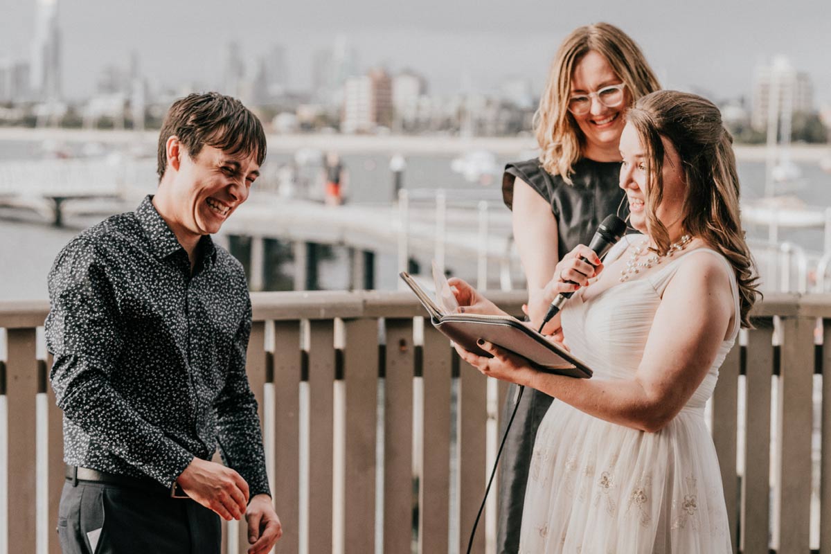 funny wedding ceremony moment where bride told a silly love story that makes her groom laugh so much in Little Blue restaurant St Kilda pier