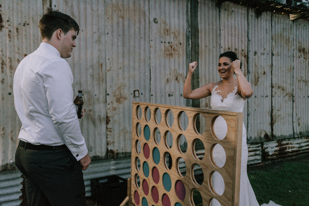 Mornington Peninsula married couple playing with board game during their barn wedding reception