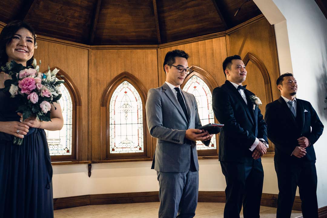 groom waited nervously for his bride to come at chapel wedding ceremony