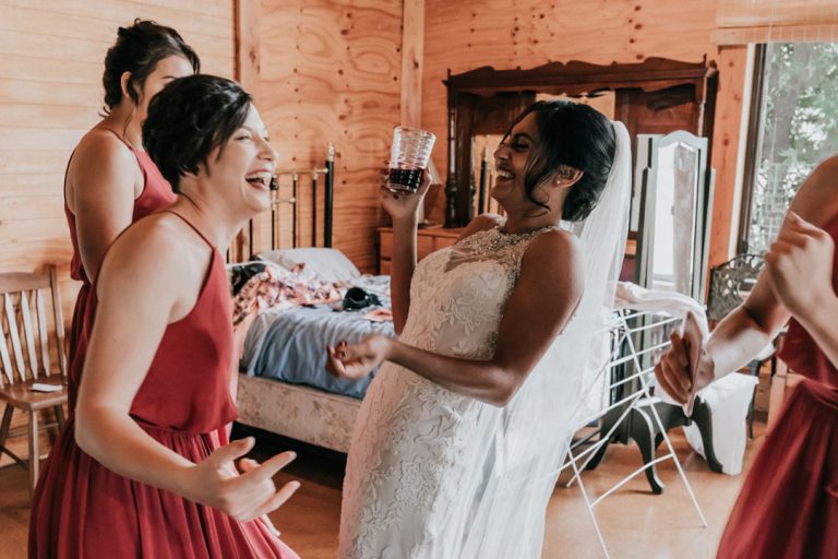 bride to be and bridesmaids laughing happily candid moment captured by Black Avenue Productions