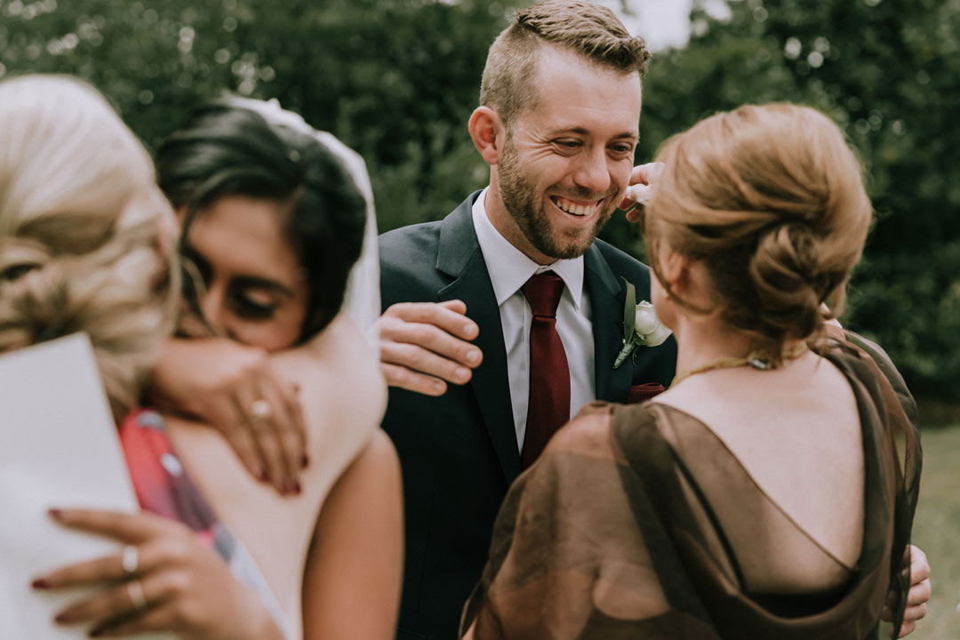 emotional moment of bride groom hugging their mothers after rustic farm wedding Melbourne captured by best wedding photographers Black Avenue Productions