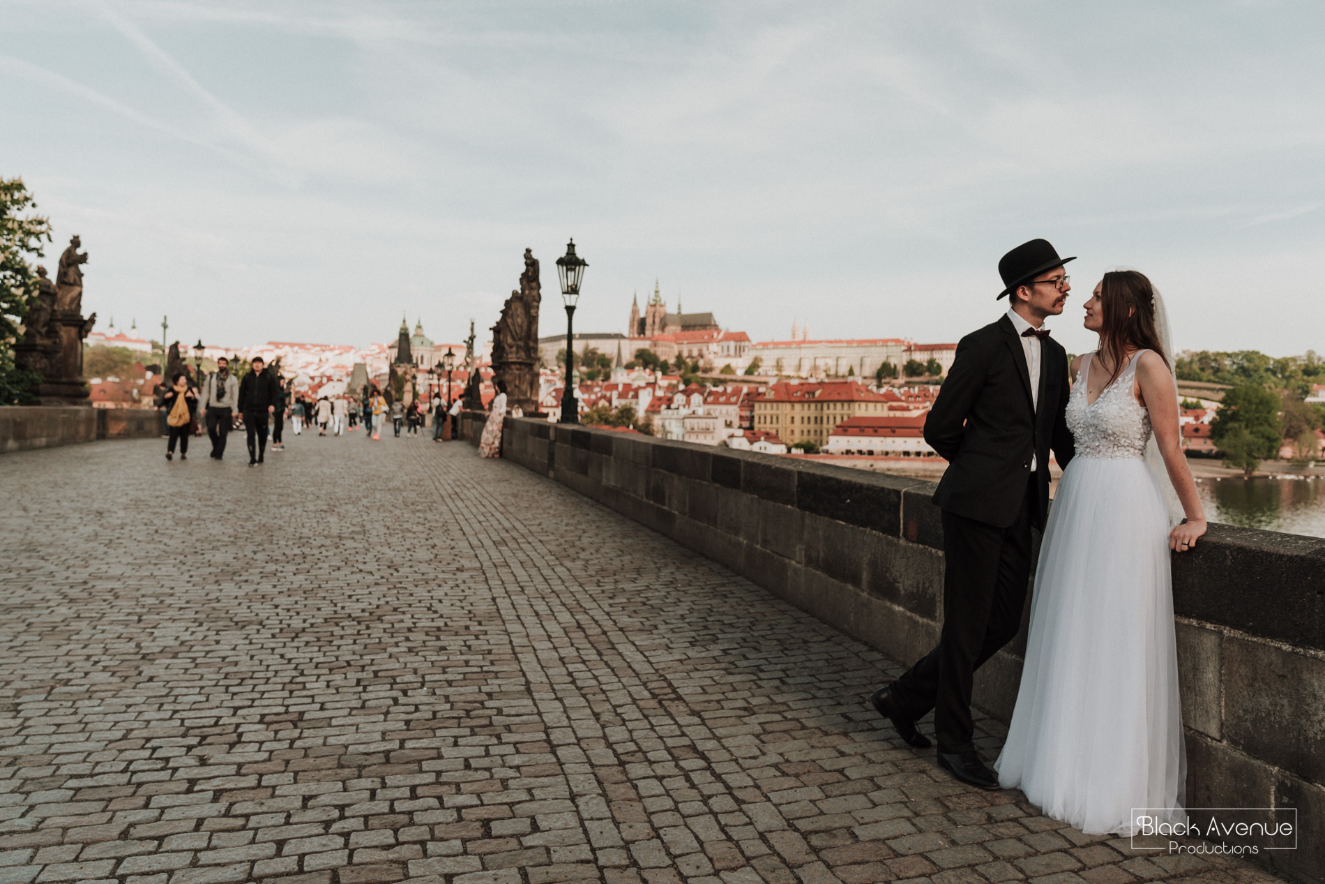 European bride and groom having a romantic moment in Prague Charles Bridge on their wedding day by destination wedding photographers from Australia