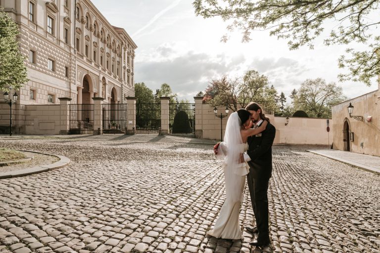 Newly wed couple walk around the cobblestone for their Prague destination wedding photography session with Derek Chan and Lowina Blackman from Melbourne Australia