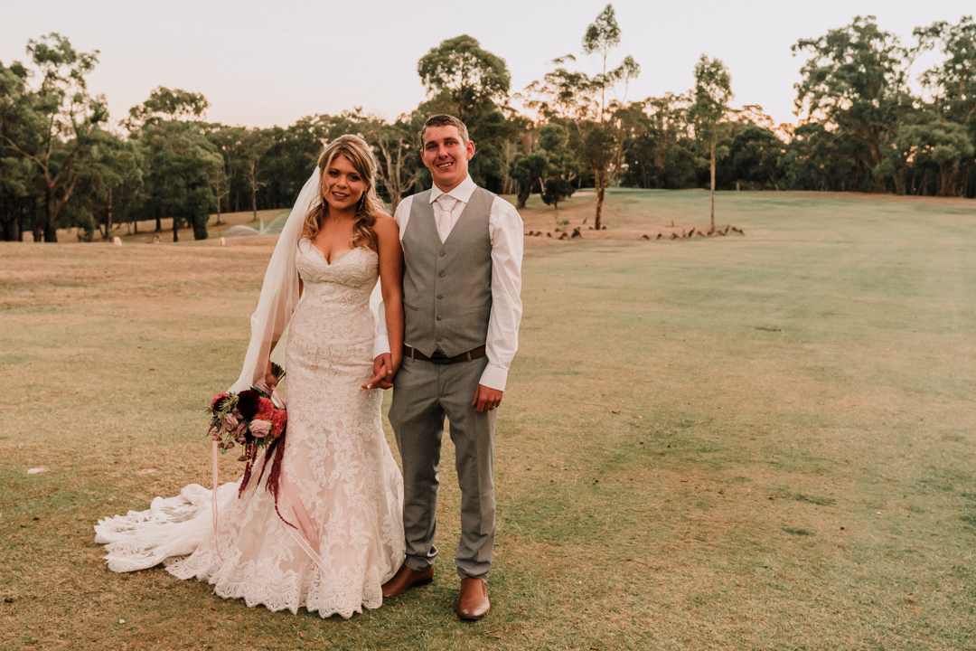 Just married couple standing with kangaroo at Wilson Botanic Park Berwick wedding captured by award winning wedding photographer Derek Chan from Black Avenue Productions