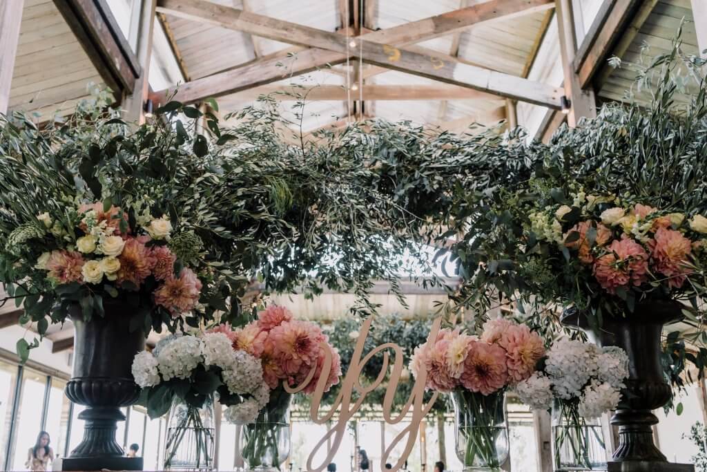 Beautiful rustic theme reception setting with floral arrangement in Stones of Yarra Valley wedding by Black Avenue Productions