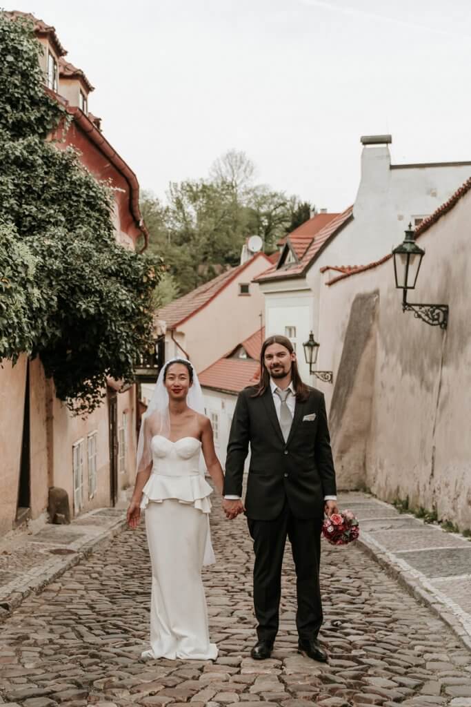 German couples taking wedding photo in Prague by destination wedding photographers Black Avenue Productions image featured in Polka Dot Bride at Expert wedding photographer interview blog