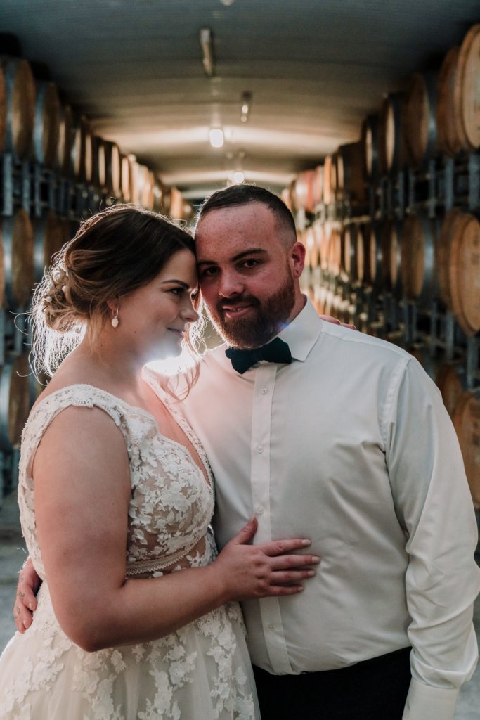 bride and groom with a winery background for wedding portrait