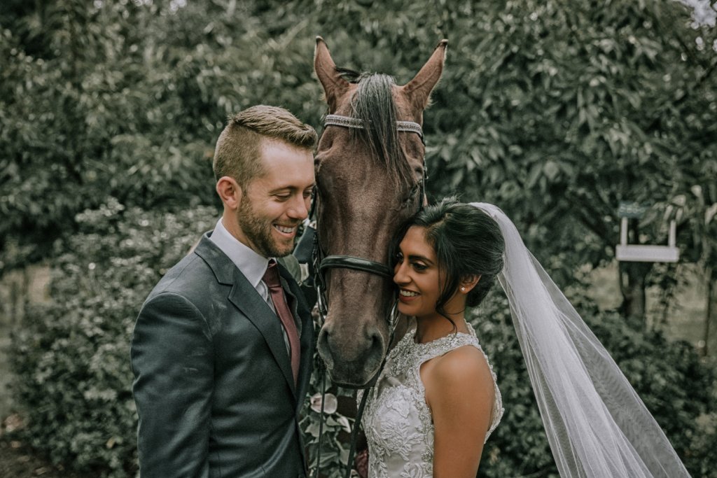 Wedding photo idea with a horse as flower girl taken by award winning photographer Black Avenue Productions in Victoria Australia for a farm wedding