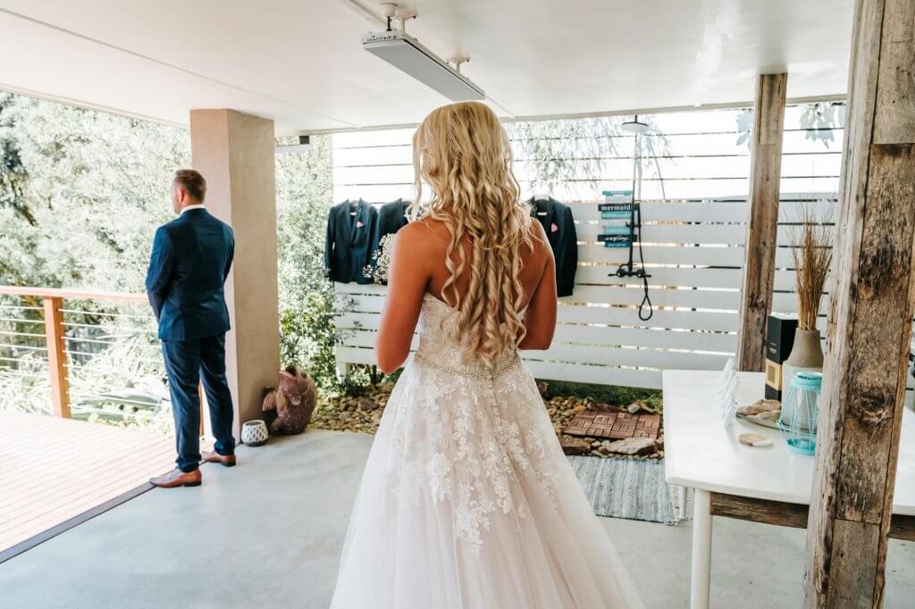 bride walking towards the groom in first look wedding tradition