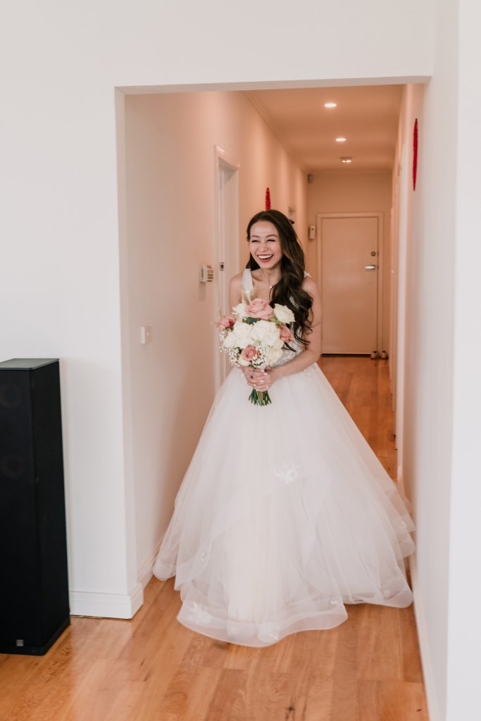 asian bride in white gown with flower bouquet