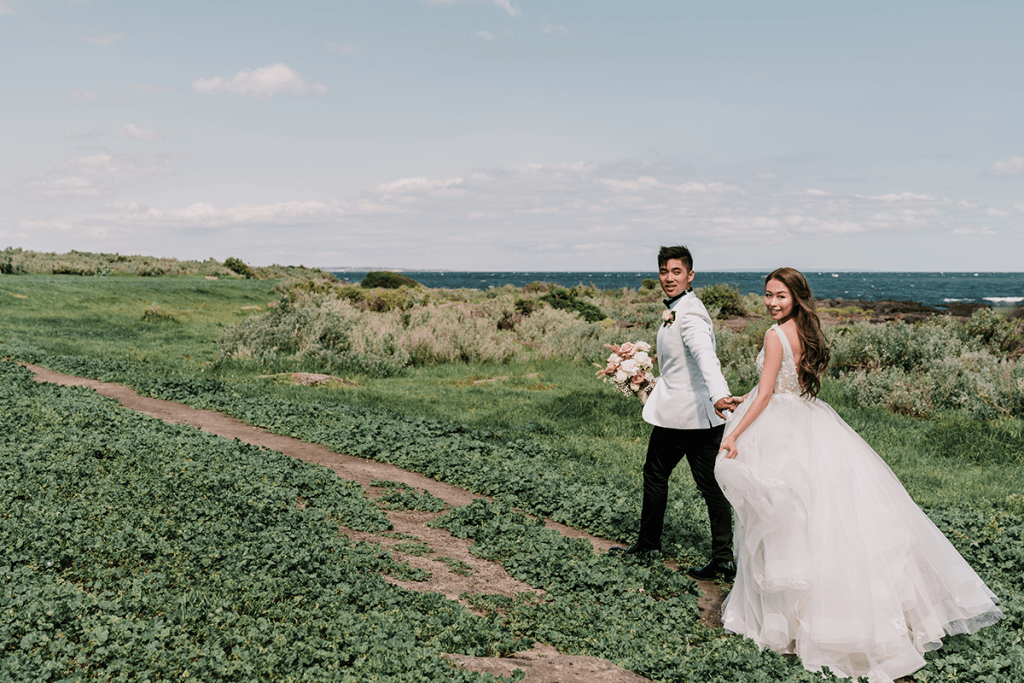 asian couples in a plain green field in Melbourne shot by black avenue productions