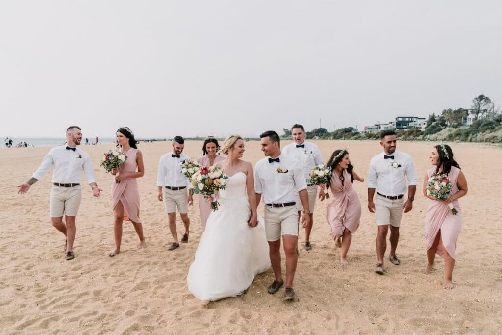 married couple together with bridal entourage in a beach wedding at Brighton Savoy shot by award winning wedding photographers Black Avenue Productions