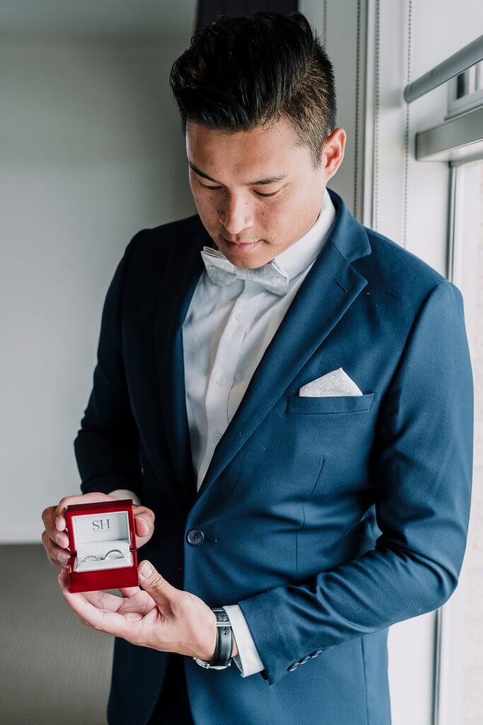 groom holding a ring in the red box before wedding ceremony in Victoria, Australia