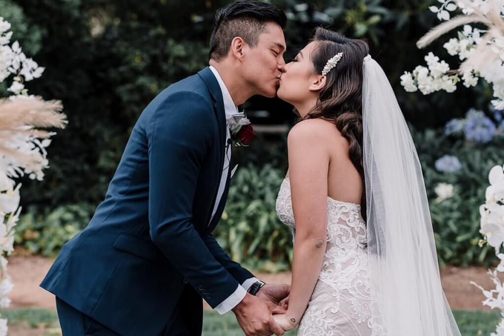 Groom and Bride kiss in a wedding ceremony