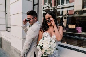 newly wed couples wearing sunglasses in wedding outfits