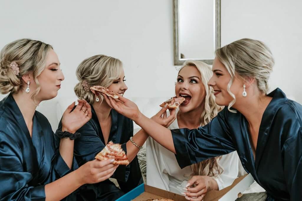 happy moments with bride and bridesmaids while eating pizza