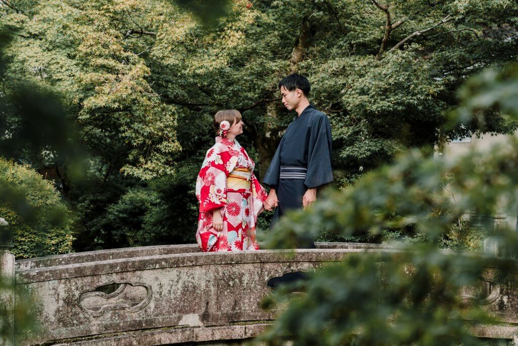 Destination Wedding Photography couple standing by a bridge in Japan