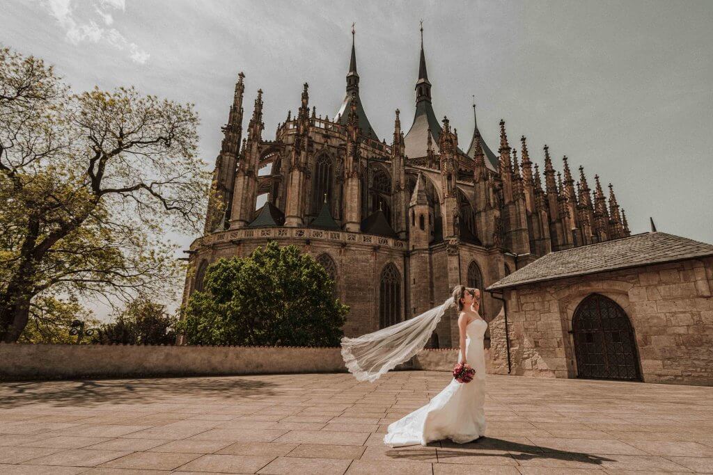 Destination Wedding Photography Bride standing outside a cathedral