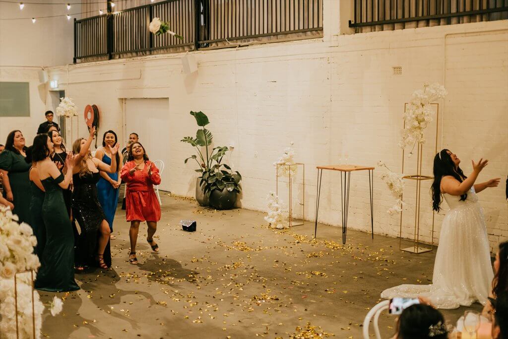 ladies excited to participate as the bride tossed the flowers captured by black avenue productions