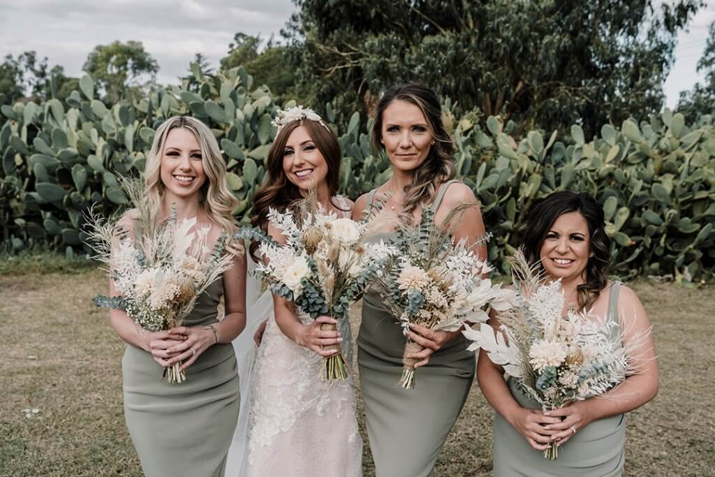 lovely bride with bridesmaids showing their bouquets. captured by black avenue productions