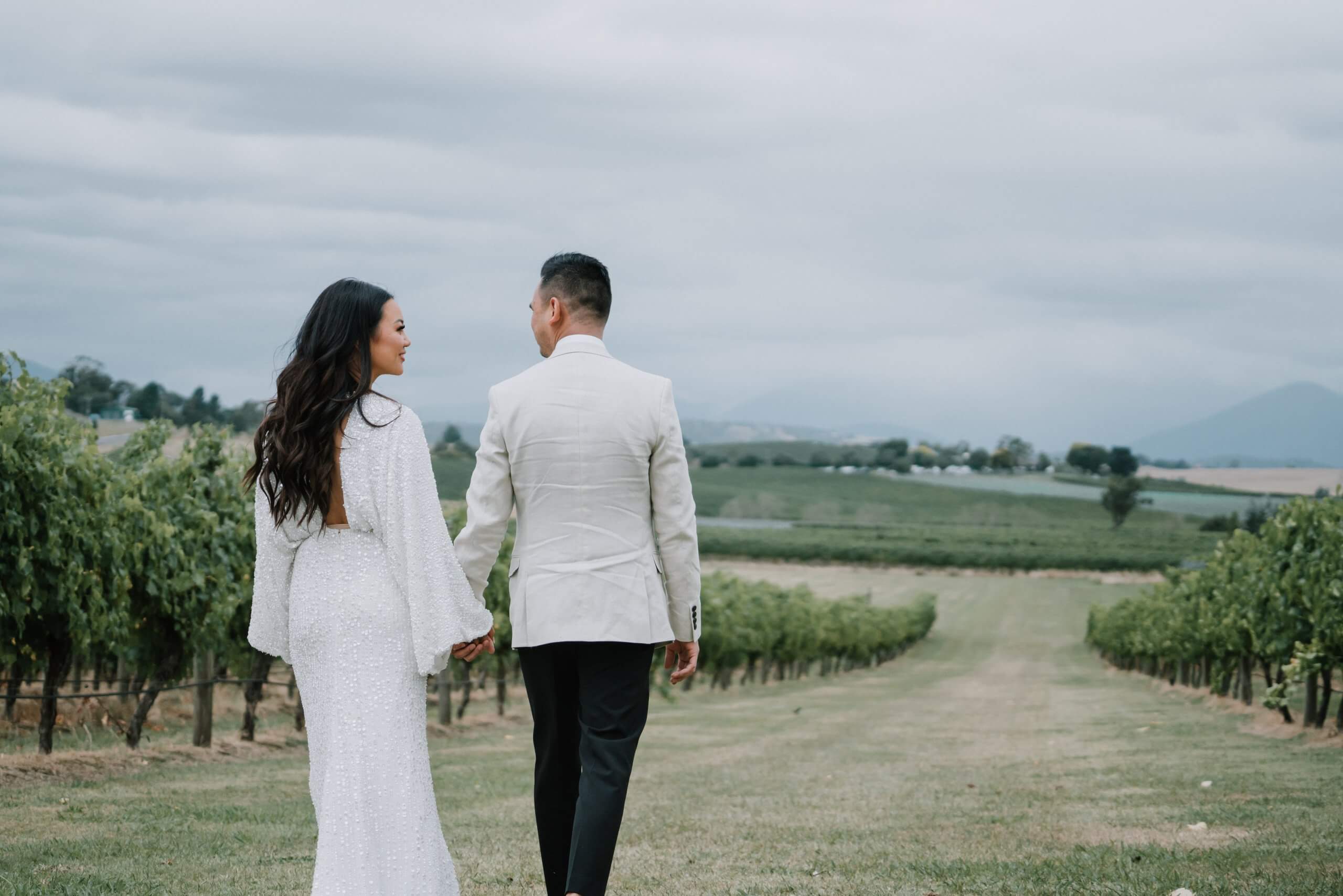 Bride and Groom enjoying the beautiful field. Captured by Black Avenue Productions