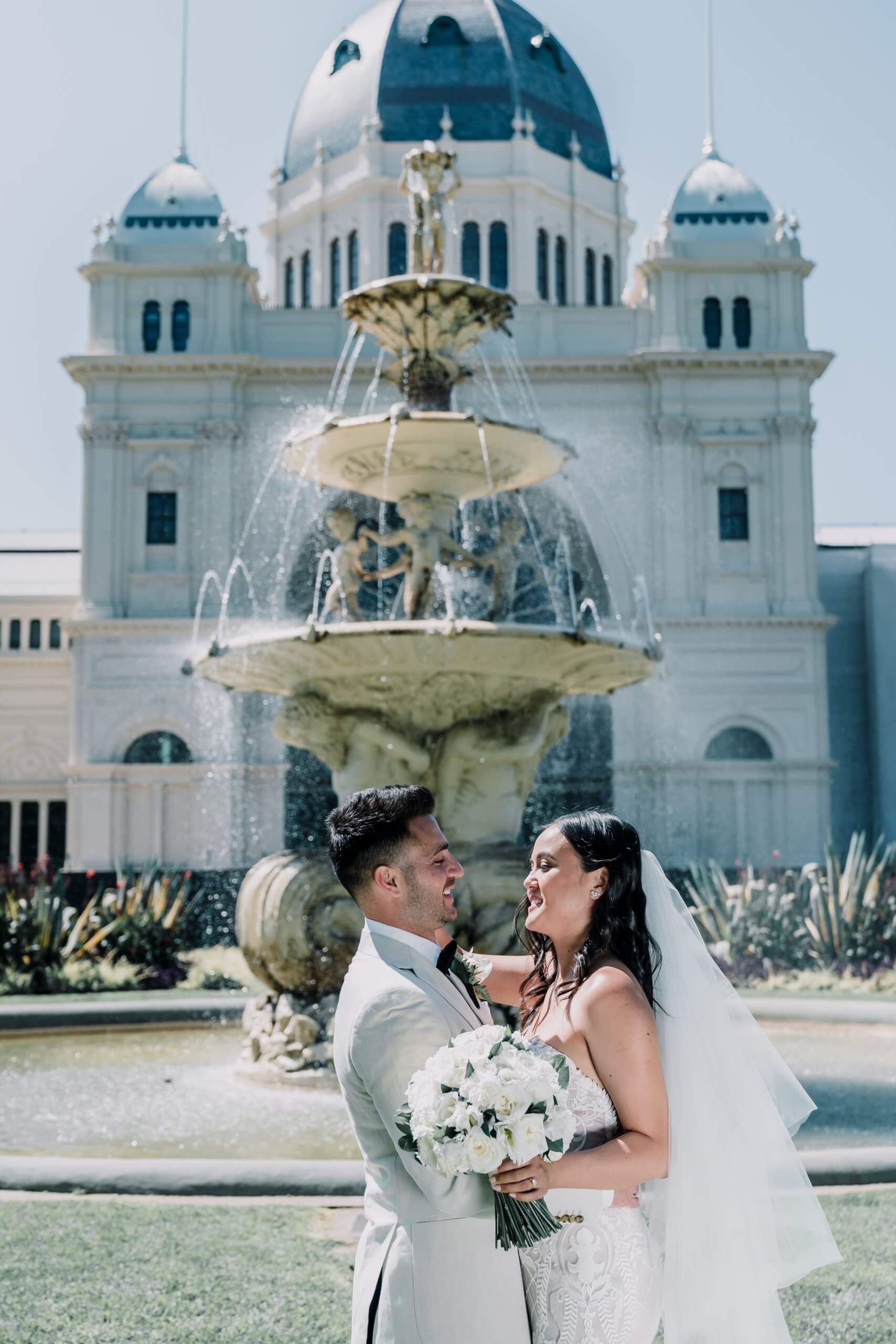 Lovely couple looking at each other with love by the Fountain, a perfect wedding shoot location. Captured by Black Avenue Productions