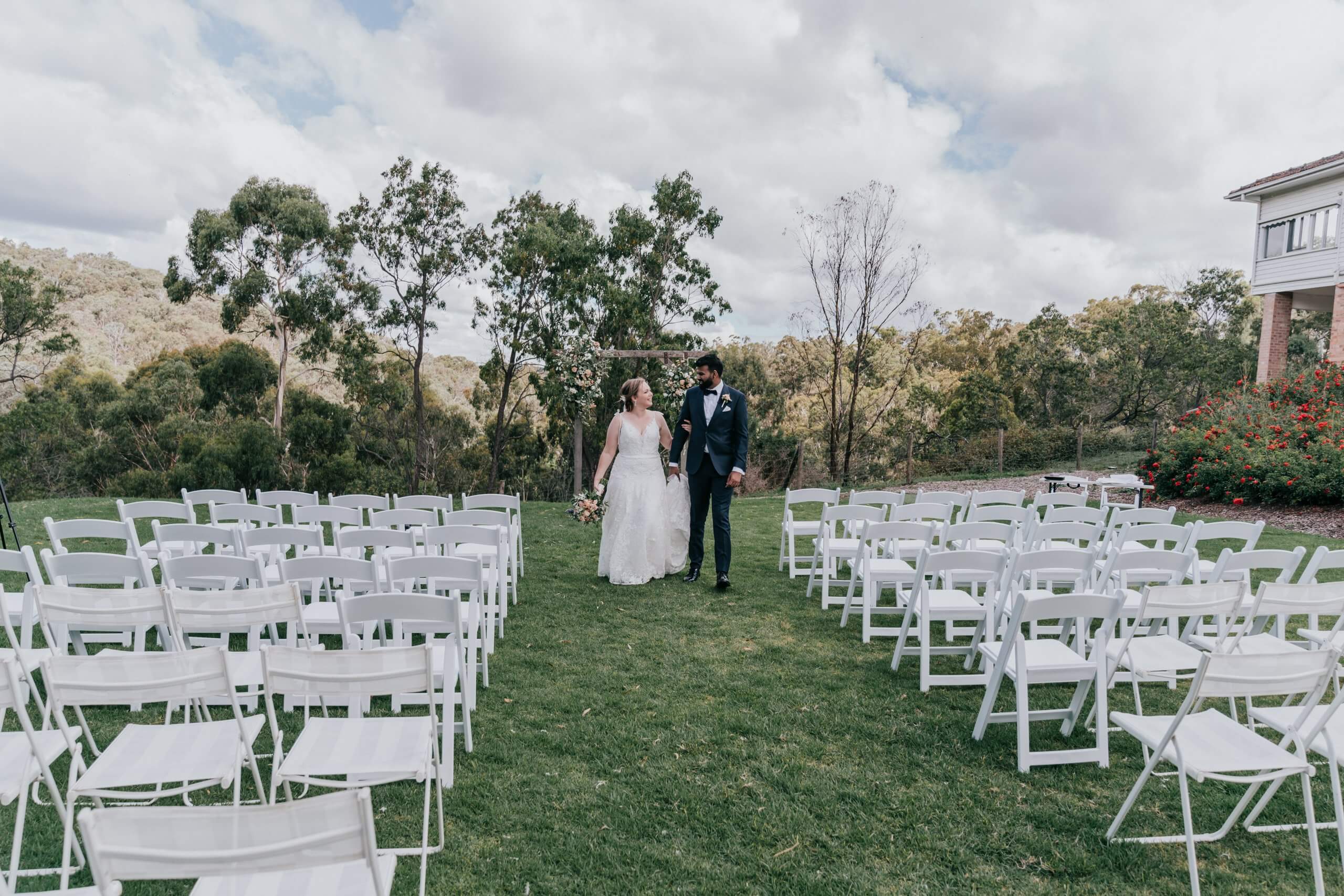 The right wedding suppliers, these white chairs matched the beautiful sky during this couple's wedding, captured by Black Avenue Productions