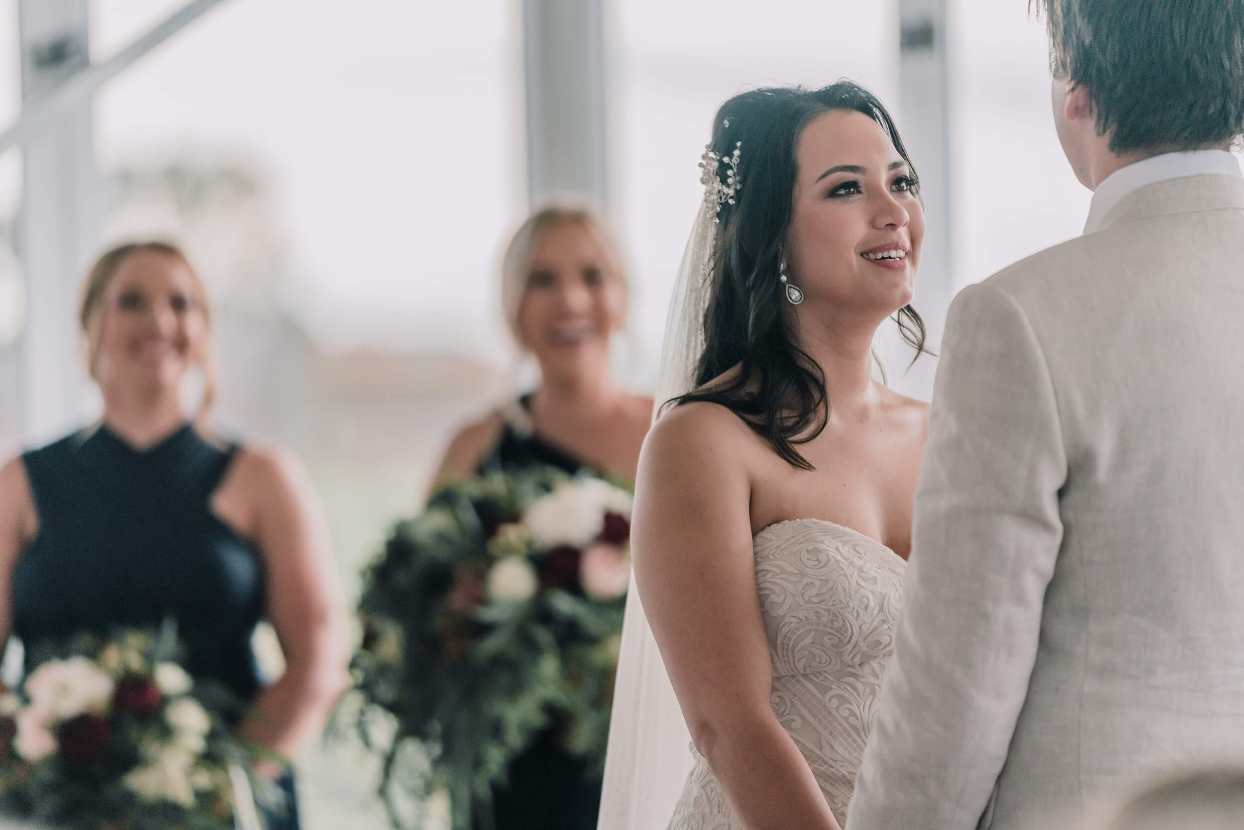 Beautiful bride smiling while looking at her groom, captured by Black Avenue Productions