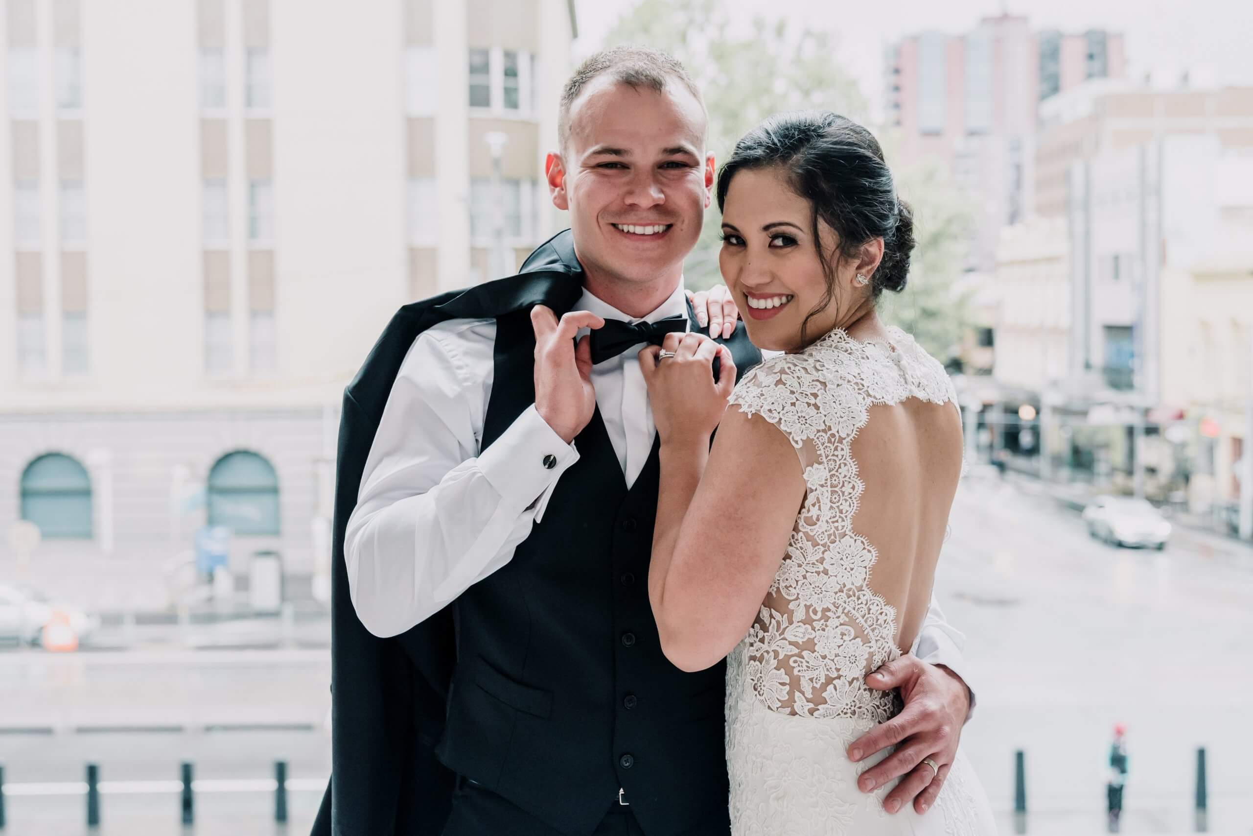 Newlyweds happily posing outside the wedding venue, captured by Black Avenue Productions