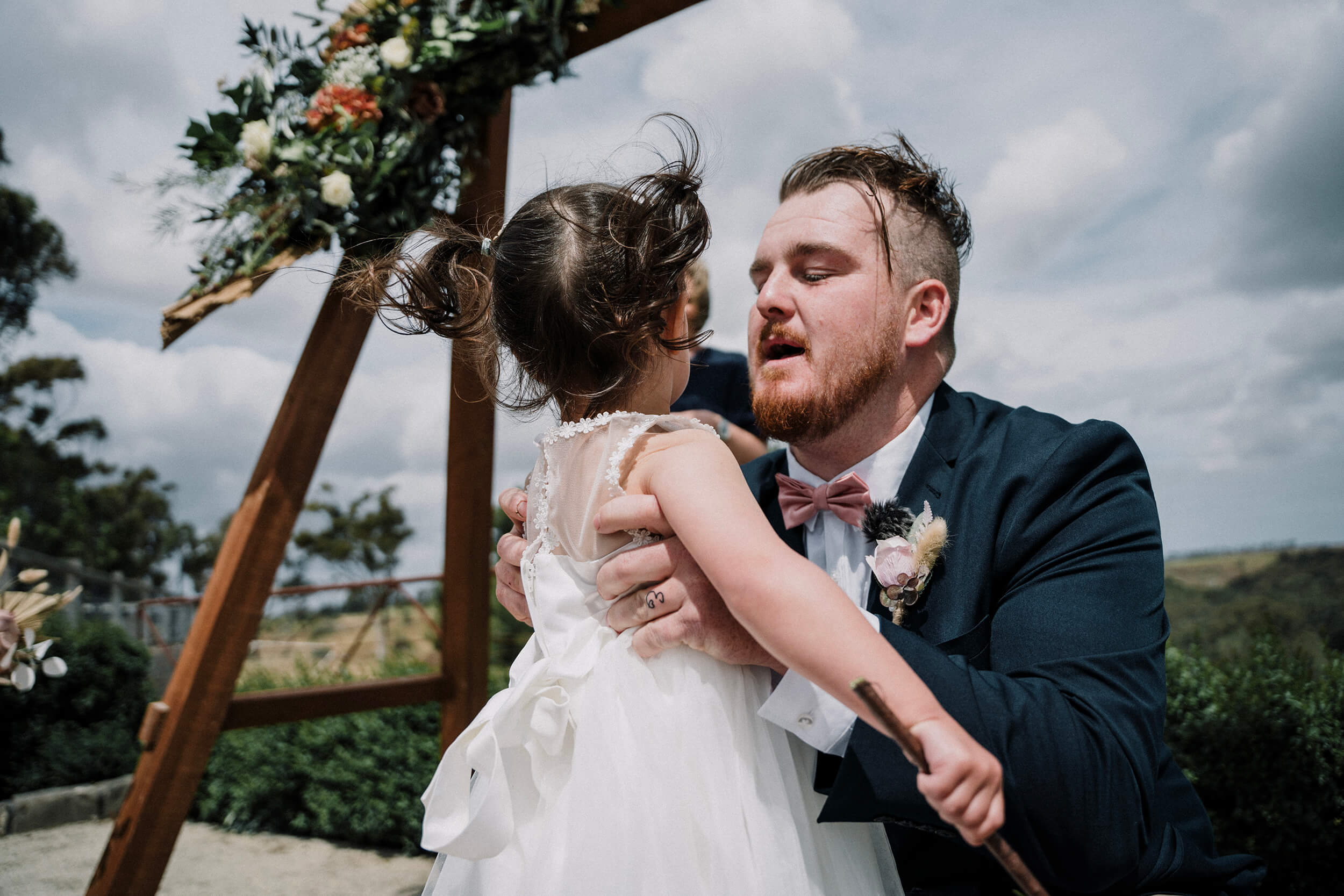 The groom holding his daughter in the ceremony. Photo captured by Black Avenue Productions