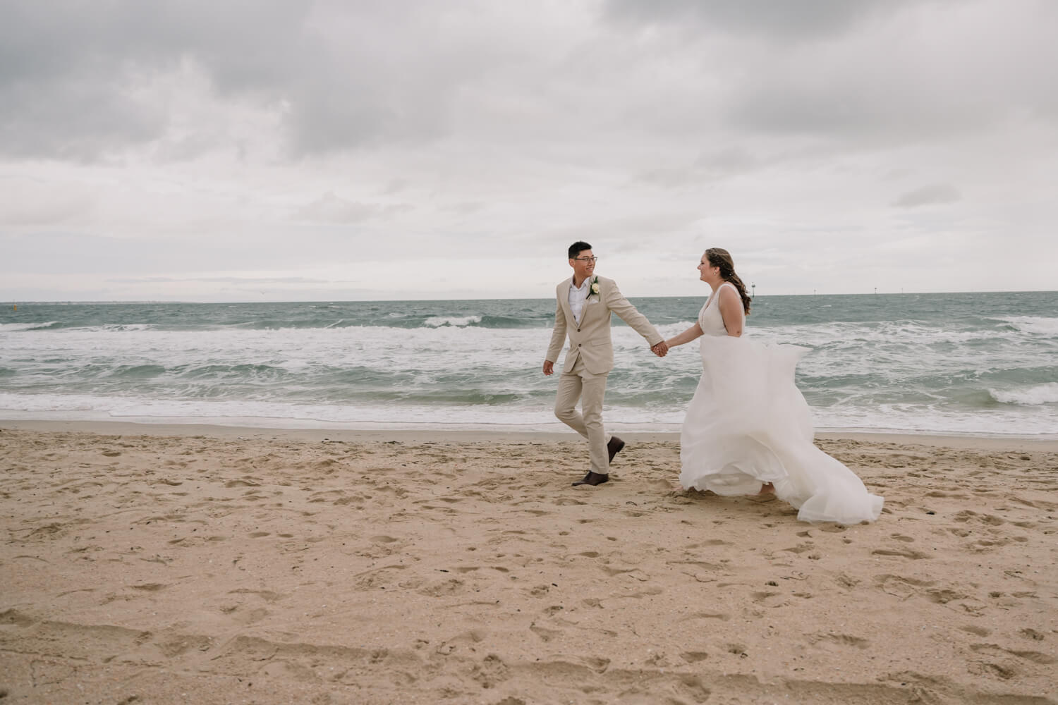 Engagement Shoot Mistakes To Avoid, Lovely Couple walking by the beach while holding each other's hand, Captured by Black Avenue Productions