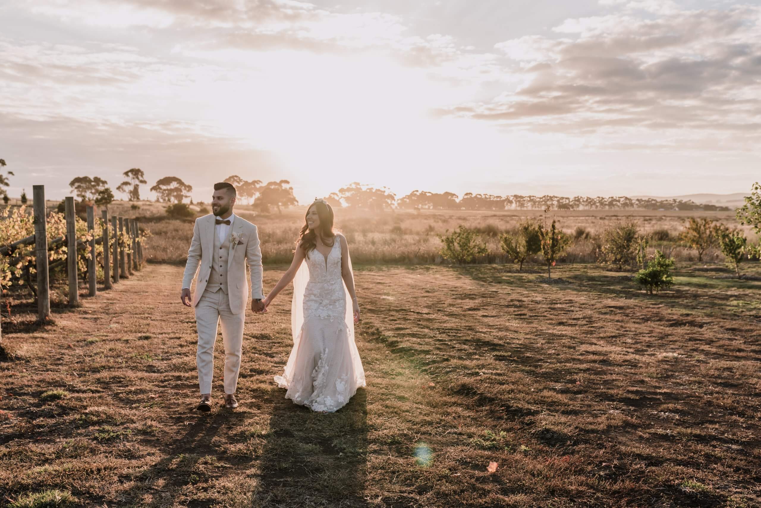 Engagement Shoot Mistakes To Avoid, Golden hour shot of the couple walking while holding each other's hands Captured by Black Avenue Productions
