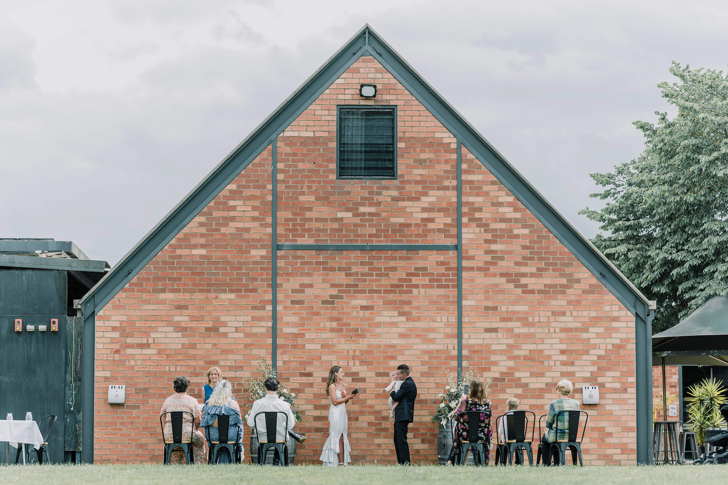 A very intimate wedding ceremony in an outdoor setting with the close friends and family of the bride and groom watching the ceremony. Captured by Black Avenue ProductionsPlanning An Intimate Wedding