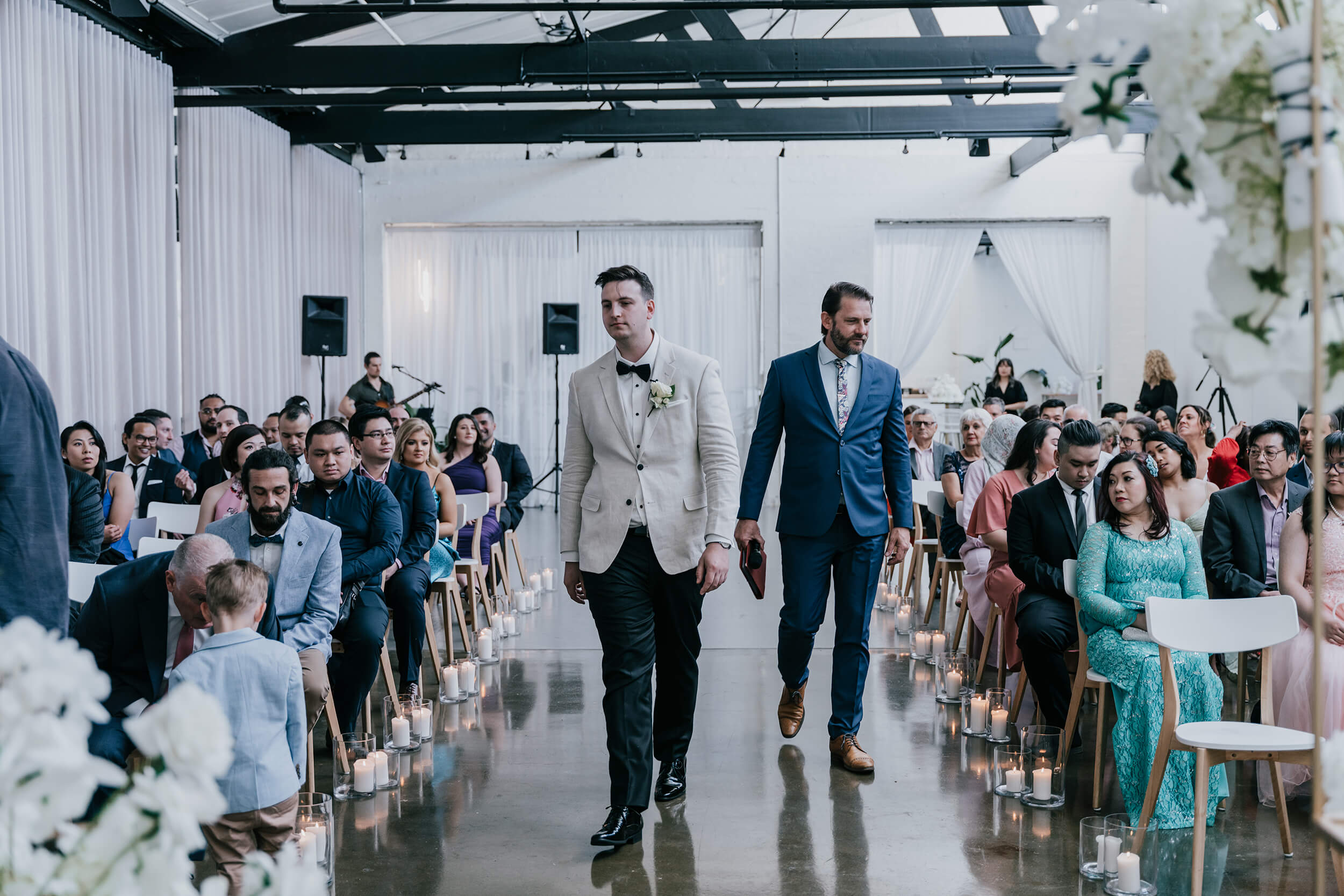 Planning An Intimate Wedding, Groom with bet man walking down the aisle in preparation for the wedding. Captured by Black Avenue Productions