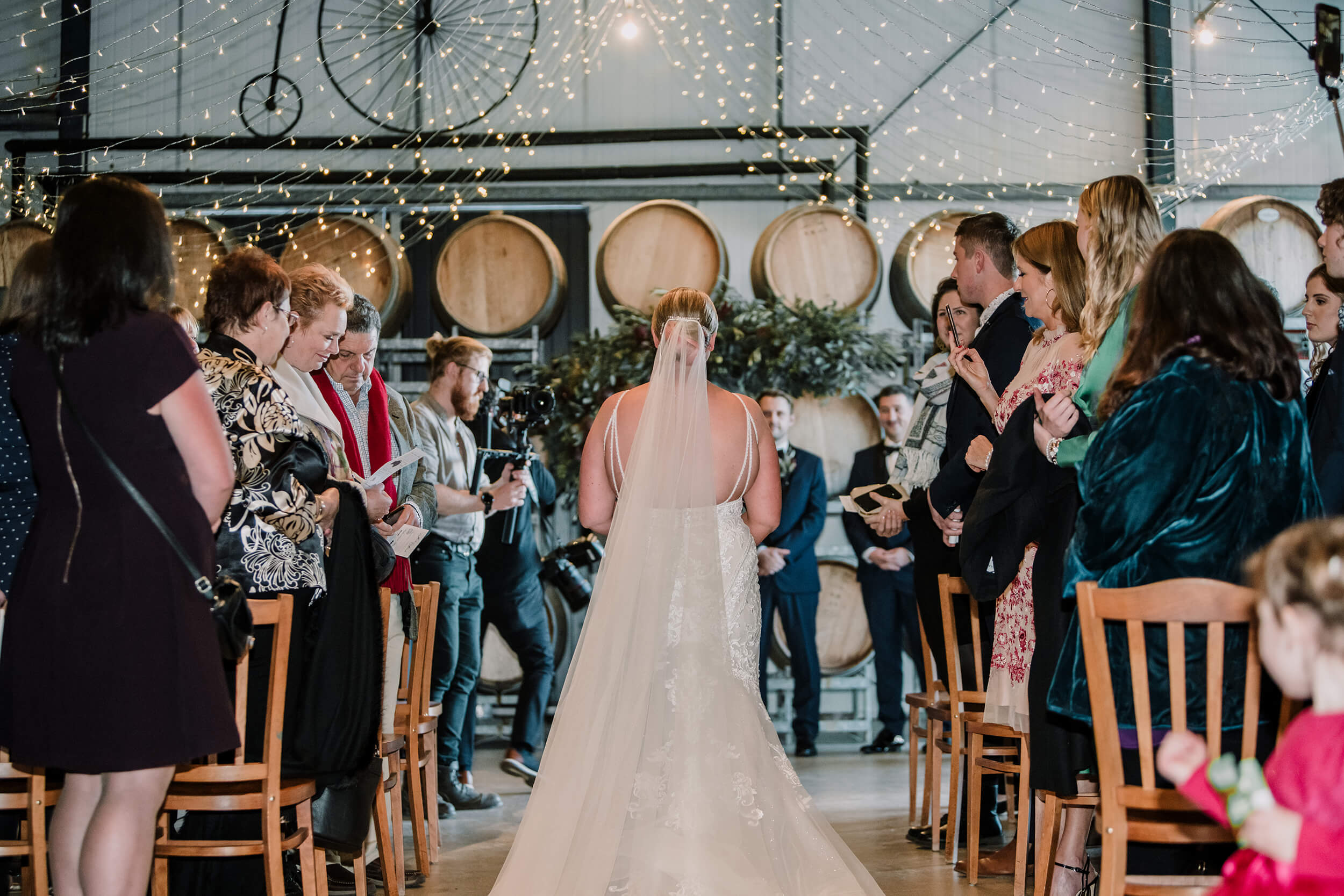 Beautiful bride walking down the aisle in this beautiful winery venue. Captured by Black Avenue Productions
