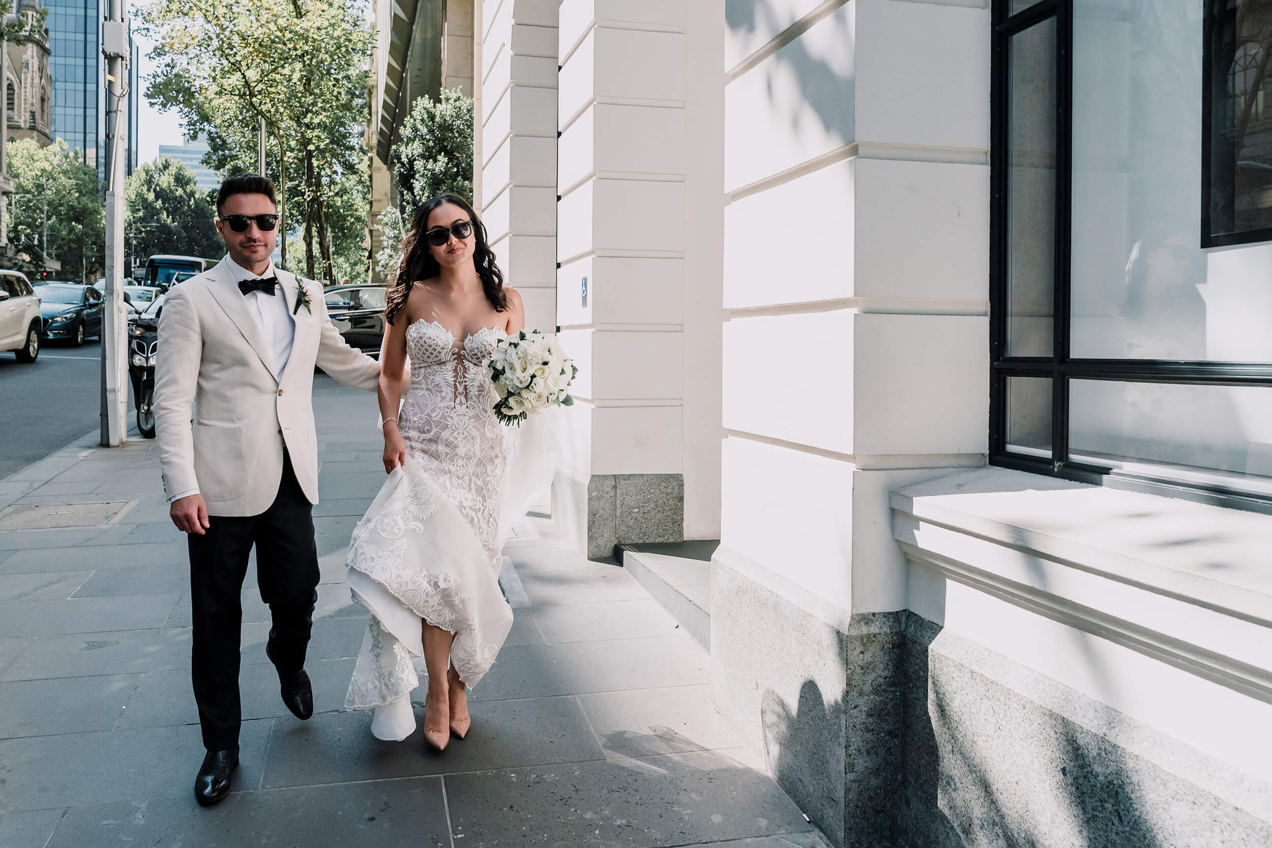 Engagement Shoot Preparations, bride and groom walking by the street wearing shades , captured by Black Avenue Productions