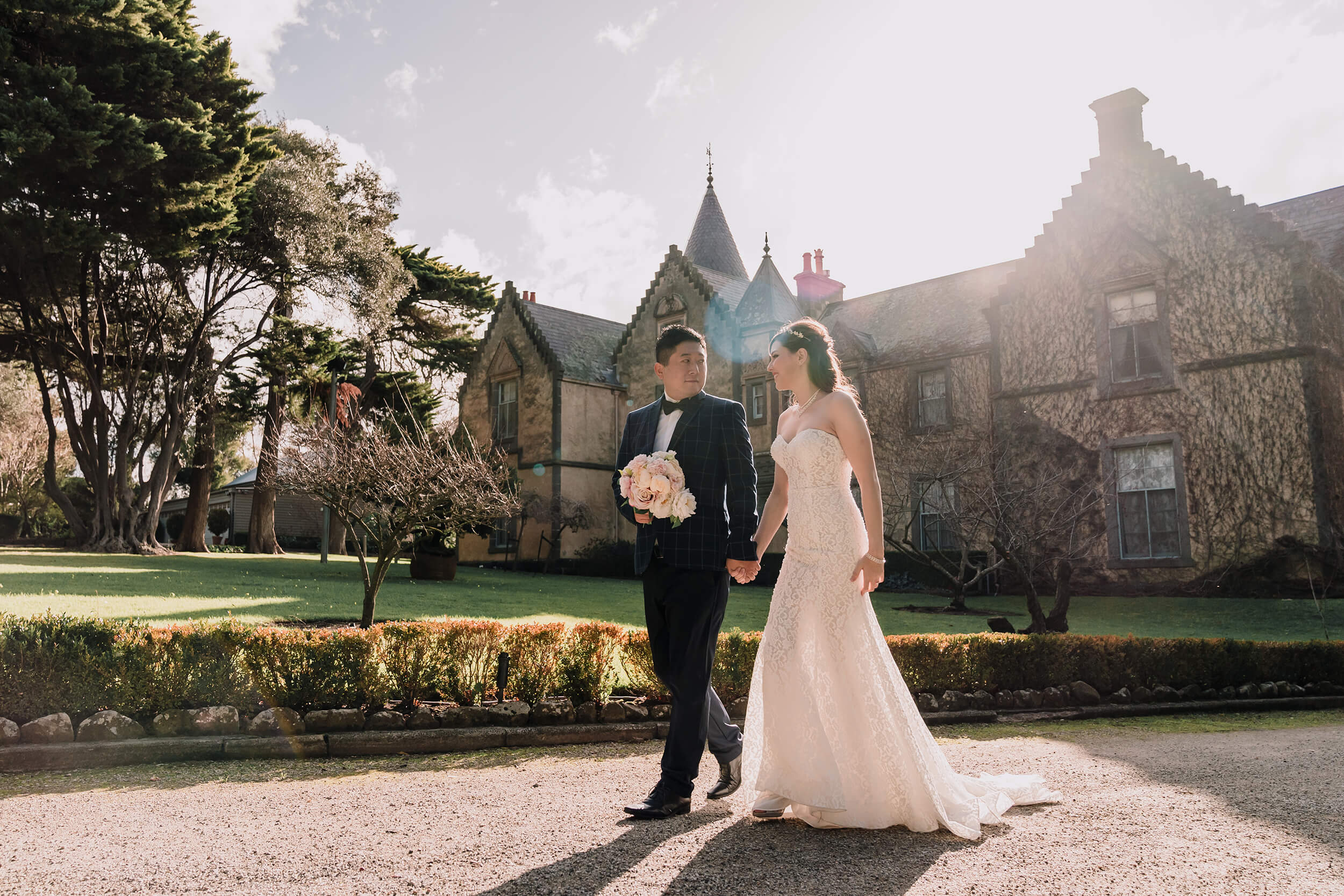 Lovely shot of the couple as they stroll outside the mansion, captured by Black Avenue Productions