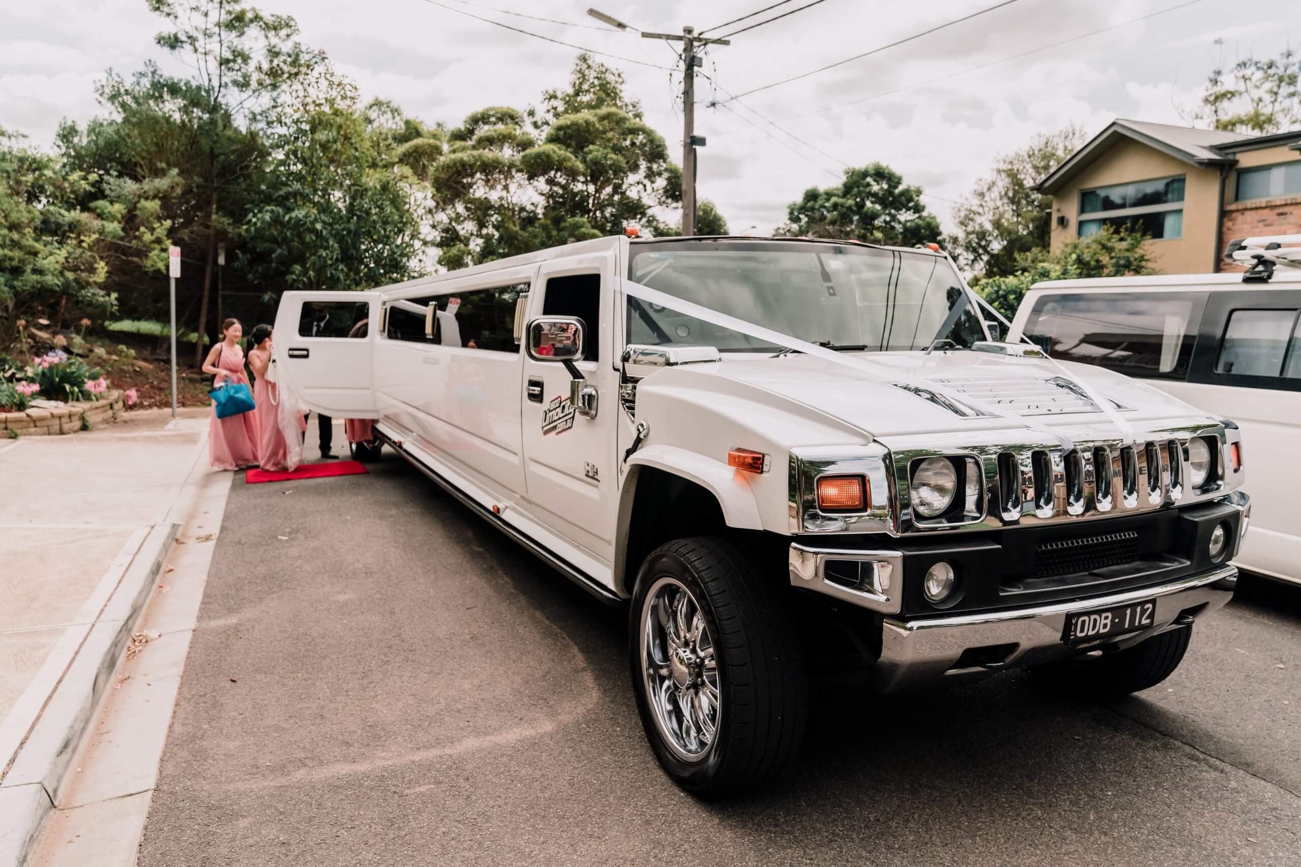 This white hummer limousine was the couples choice for their wedding car. Captured by Black Avenue Productions