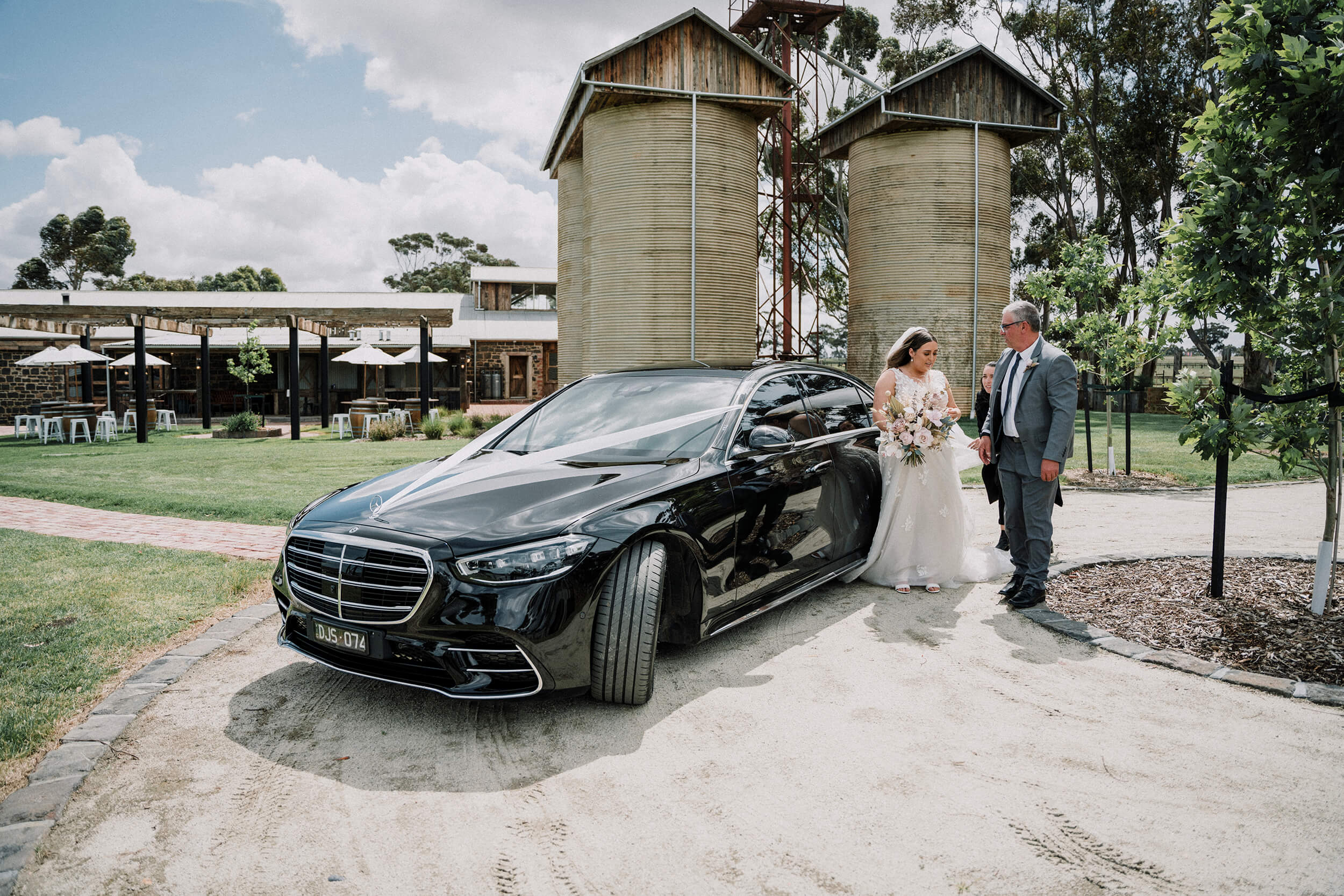 Get a wedding car, bride went down a black wedding car, assisted by her father. captured by Black Avenue Productions