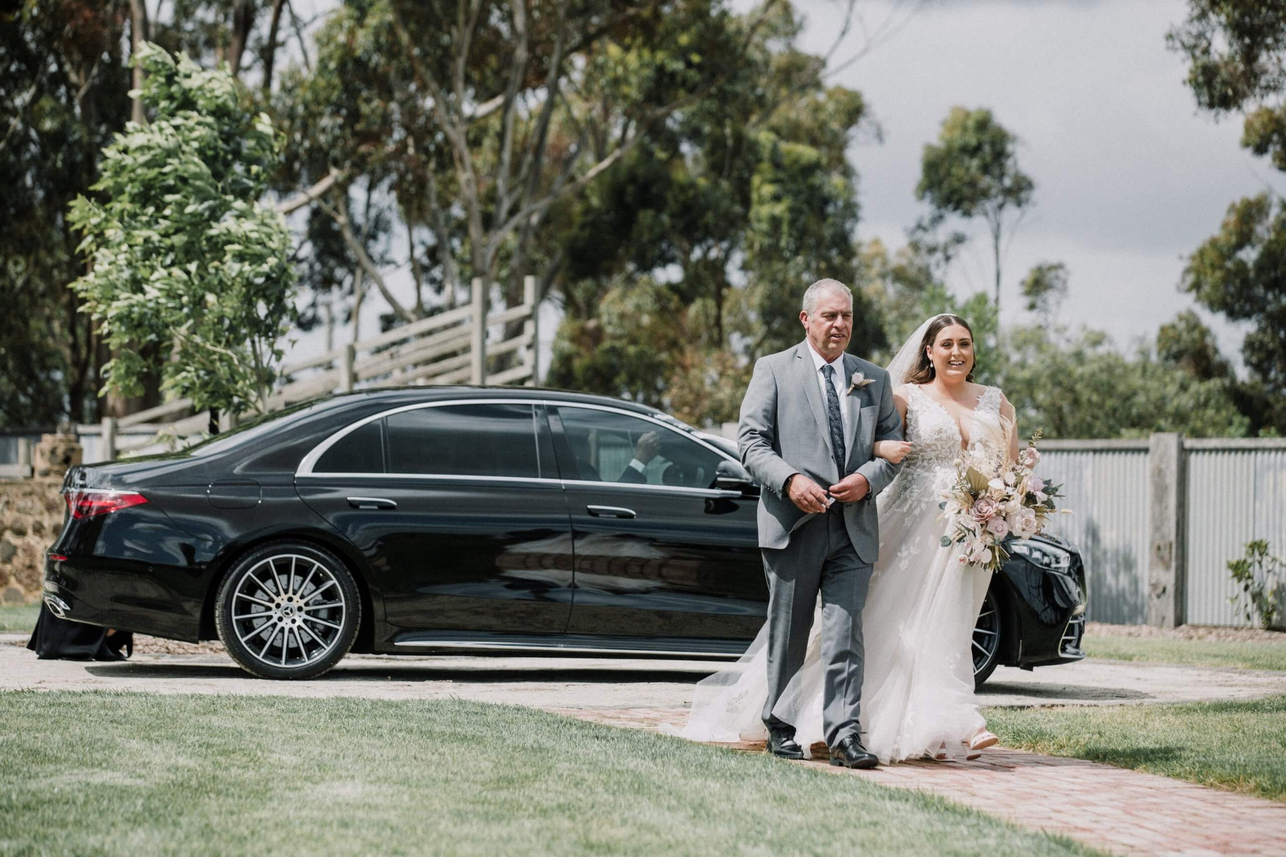 Father walks her daughter from the wedding car to the altar. Captured by Black Avenue Productions