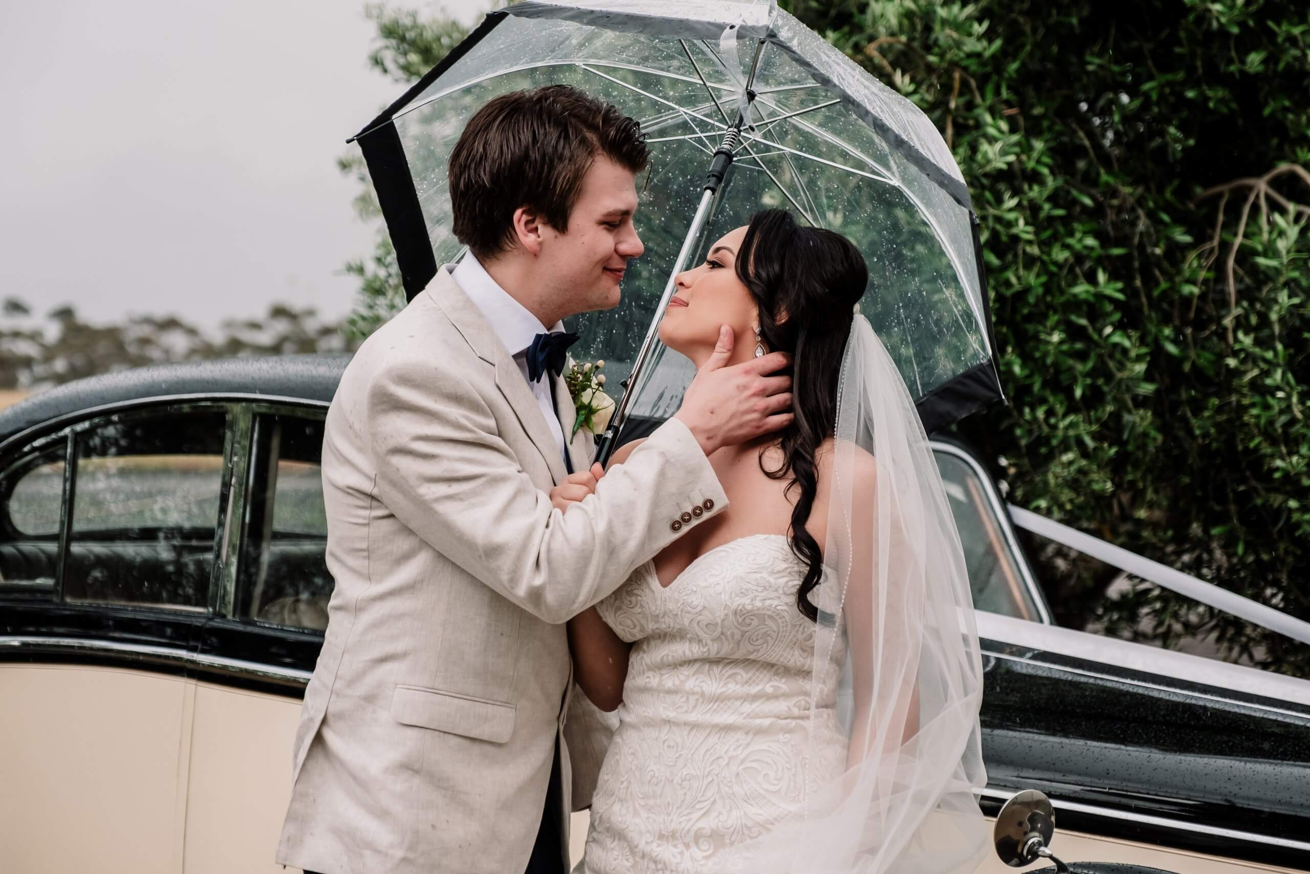 Groom and Bride almost kisses each other whilst standing outside the church. Captured by Black Avenue Productions